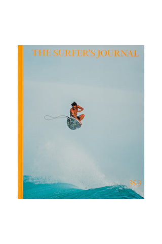 Cover of 'The Surfer's Journal' magazine with a surfer in mid-air over a wave.