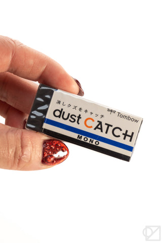 MONO Dust Catch eraser with Dust Catch label, held in a hand