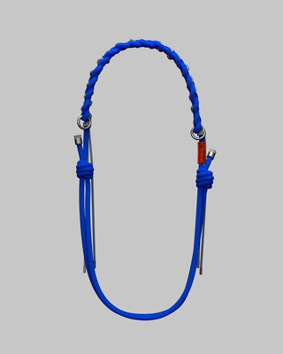 Bright blue braided adjustable rope strap on a light gray background