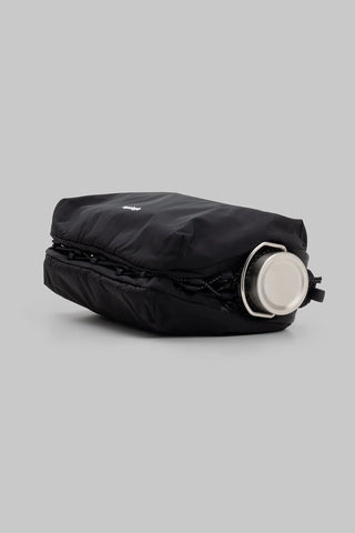 Topologie large sacoche bag laying flat with water bottle inside against a light gray background