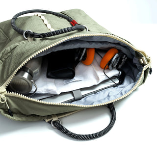 Open helmet bag interior with compartments, straps, and bundled gear
