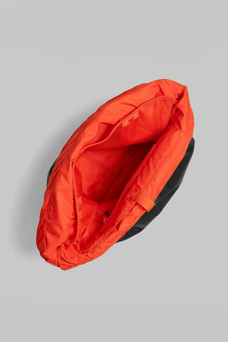 Red helmet bag shown open, with padded interior and zipper opening