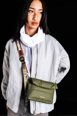 Olive utility sling bag with adjustable shoulder strap and metal hardware