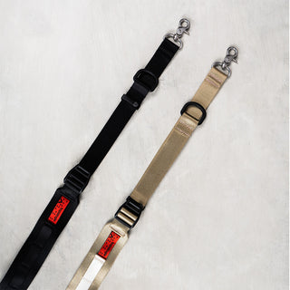 Wide utility sling straps: one black, one tan with metal clasps