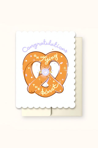 White scalloped wedding greeting card with orange 'Congratulations' rings and bow