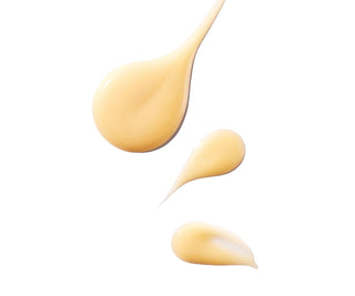 Swatches of yellow vitamin c serum on white background