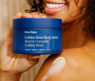 Ursa Major body butter jar with Golden Hour label; creamy smear on arm