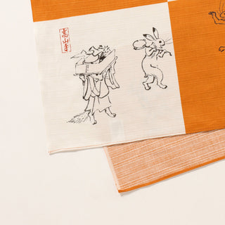Cloth with traditional Japanese illustrations on an orange textured background