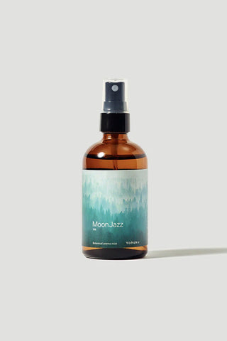 Brown spray bottle labeled 'Moon Jazz' on a light gray background
