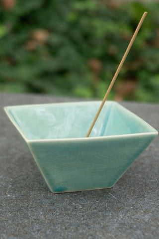Green glazed incense burner bowl with upright incense stick