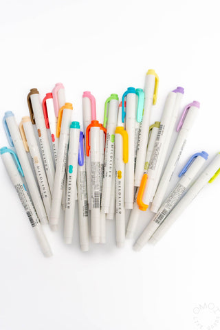 Assorted colorful markers on a white background