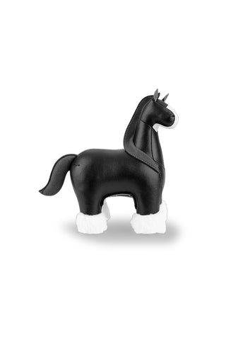 Black horse-shaped paperweight on a white background