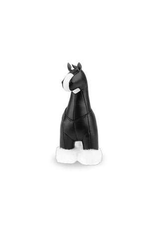 Black horse paperweight on a white background