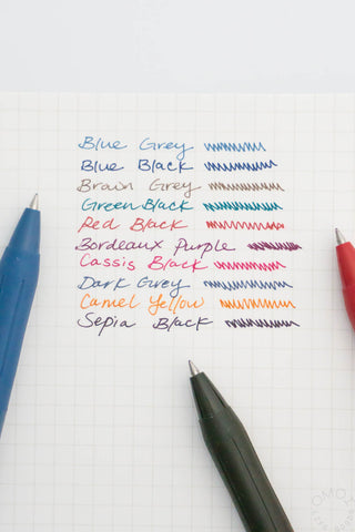 Ink color swatches on paper with pens below