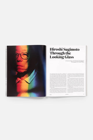 Open photography magazine with Hiroshi Sugimoto article page and portrait image