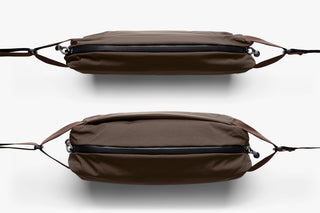 Two brown crossbody bags with black zippers on a white background to show thickness