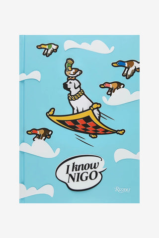 Book cover with cartoon dog flying on a carpet with cartoon birds and 'I know NIGO' text on a blue background