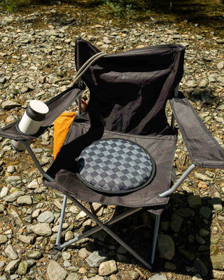 Gray checkerboard seat pad on folding outdoor chair with black frame