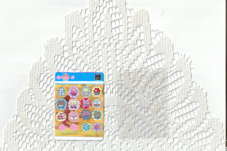 Colorful bear sticker sheet and clear card sleeve on a white lace background