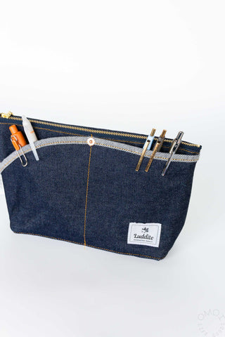 Medium denim Luddite pouch with pens inside front pockets on a white background