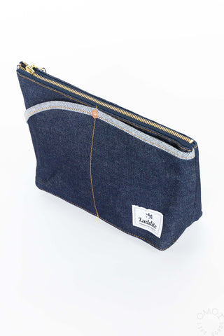 Angled view of medium denim Luddite pouch on a white background