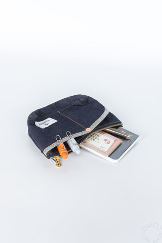 Small denim Luddite pouch with notebooks and pens inside on a white background