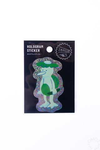 Holographic kappa sticker with green and blue hologram pattern on backing card