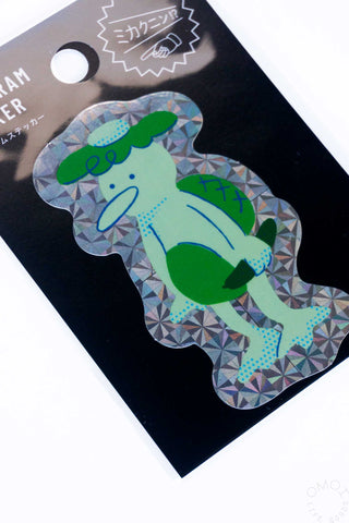 Holographic kappa sticker in green and blue with geometric foil pattern, close view