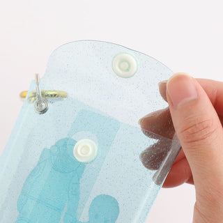 Close-up of white snap buttons on a light blue alien mini case with loop hardware