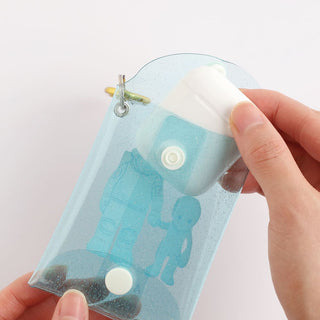 Light blue alien mini case shown in hand with white snap fastener and clear back