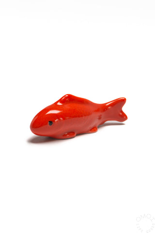 Red ceramic fish chopstick rest with small black eye detail