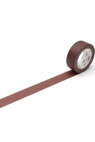 Brown washi tape rolled out on a white background