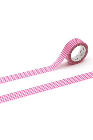 Pink and white checkered washi tape rolled out on a white background