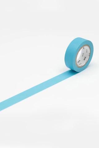 Roll of blue washi tape on a white background