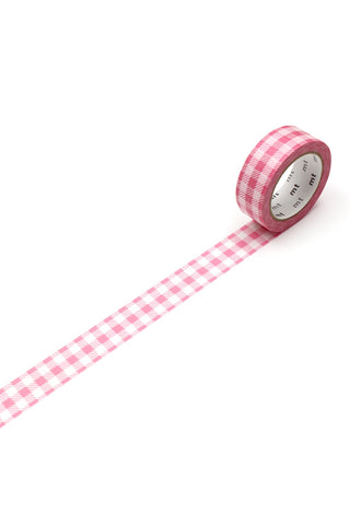 Pink checkered washi tape rolled out on a white background