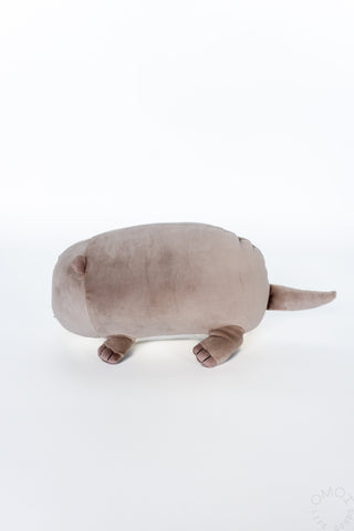 Side profile of otter plush on a white background