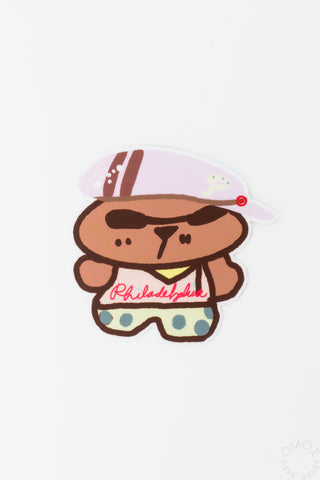 Bear sticker with a pink and yellow hat on a white background