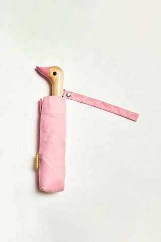 Pink umbrella with a wooden duck handle on a white background