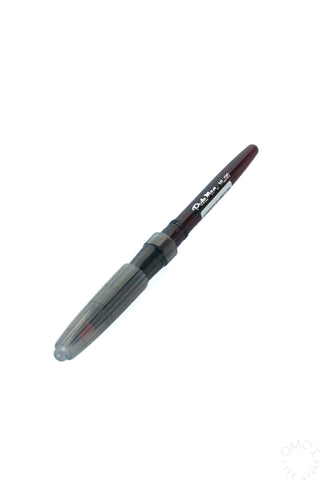 Red ink refill marker with transparent barrel and pointed tip.