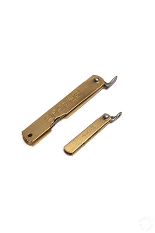 Mini pocket knives with brass handles, one blade open, both with lanyard loops