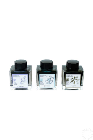 Set of Sailor bottled inks: three clear bottles with black caps and botanical labels
