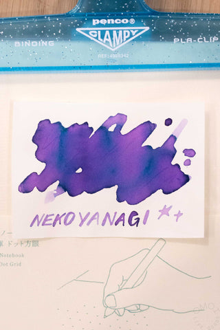 Ink swatch card with purple splash and 'NEKOYANAGI ++' text