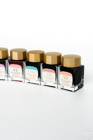 Set of Shikiori ink bottles with gold caps from the right side on a white background