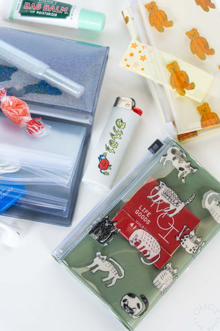 Three 5 pocket pouches with various items, lighter, and matches arranged on a white background