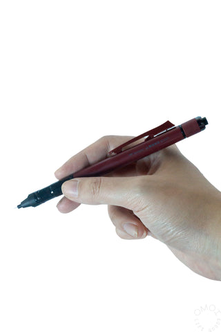 Deep red Tombow MONO Graph Tune mechanical pencil held in hand