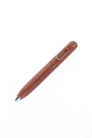 Brick red multi-color gel pen with chrome clip, tip pointing left