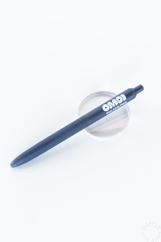 Blue OMOI zento pen on a clear stand on a white background