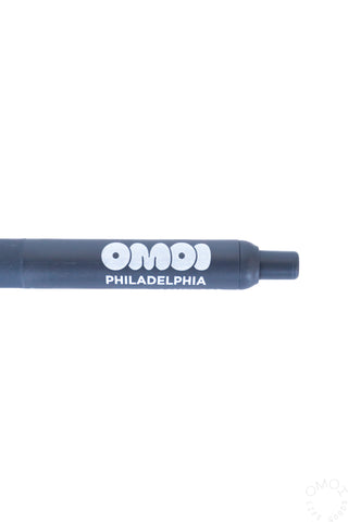 Blue-grey pen with 'OMOI Philadelphia' branding on a white background