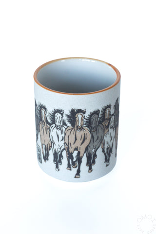 Horse teacup with black horse illustration around light blue ceramic and orange rim