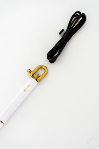 Close up of ystudio white pen top and cord on a white background